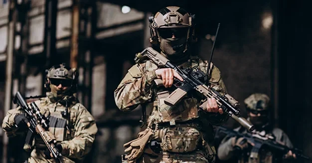 Armed military personnel in tactical gear during a training or security operation